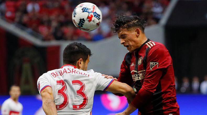 Yamil Asad (right) of Atlanta United wins a header against Steven Beitashour of Toronto FC at Mercedes-Benz Stadium on October 22, 2017 in Atlanta, Georgia. (Photo by Kevin C. Cox/Getty Images)