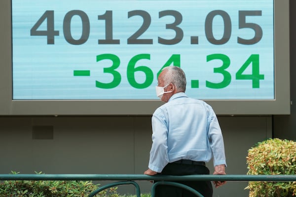 A person looks at an electronic stock board showing Japan's Nikkei index at a securities firm Tuesday, July 1, 2025, in Tokyo. (AP Photo/Eugene Hoshiko)