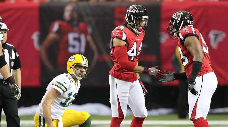 Falcons edge rusher Vic Beasley Jr. celebrates sacking Green Bay quarterback Aaron Rodgers with Dwight Freeney in the first half of a game Oct. 30. Beasley led the NFL with 15.5 sacks during the regular season. (Curtis Compton/ccompton@ajc.com)