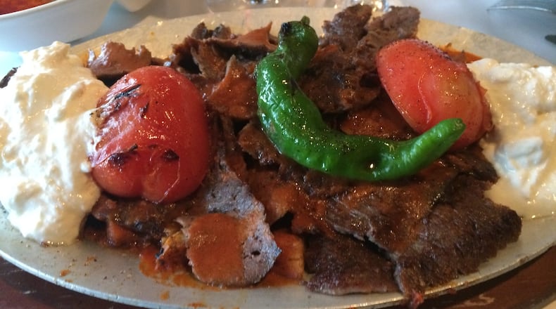 Mandolin Kitchen’s iskender is a whopping entree of sliced doner kebab meat served on a bed of pita croutons and smothered with tomato sauce. Greek yogurt is a nice accompaniment. CONTRIBUTED BY WENDELL BROCK
