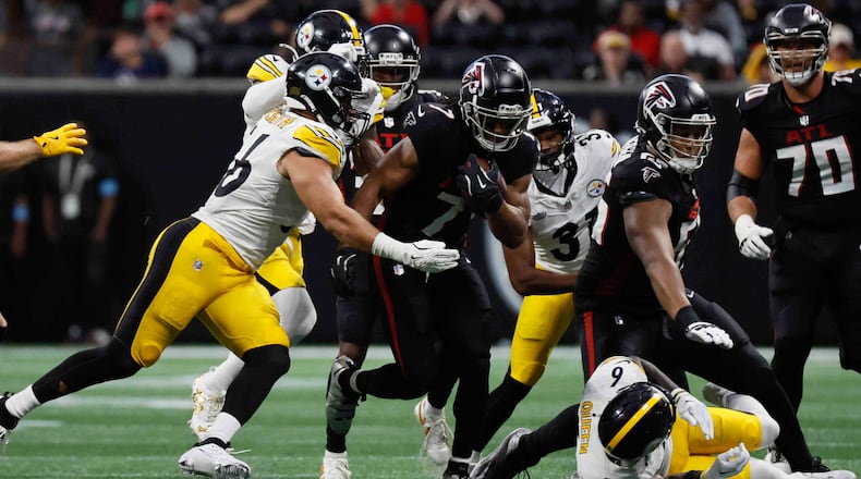 Atlanta Falcons running back Bijan Robinson (7) breaks a tackle during the second half of an NFL football game against the Pittsburgh Steelers on Sunday, Sept. 8, at Mercedes-Benz Stadium in Atlanta. 
(Miguel Martinez/ AJC)