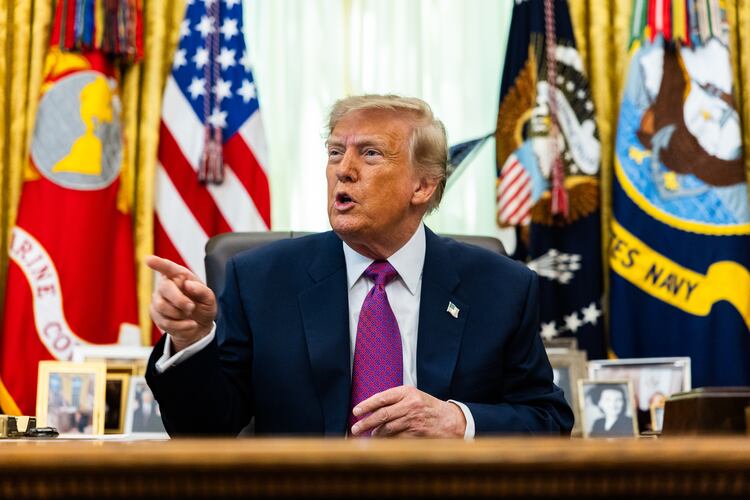 President Donald Trump speaks to reporters in the Oval Office on Thursday, Aug. 27, 2026. His administration has issued new proposed rules that would strip private schools of their tax-exempt status if they enact programs that help minority students. (Demetrius Freeman/The New York Times)