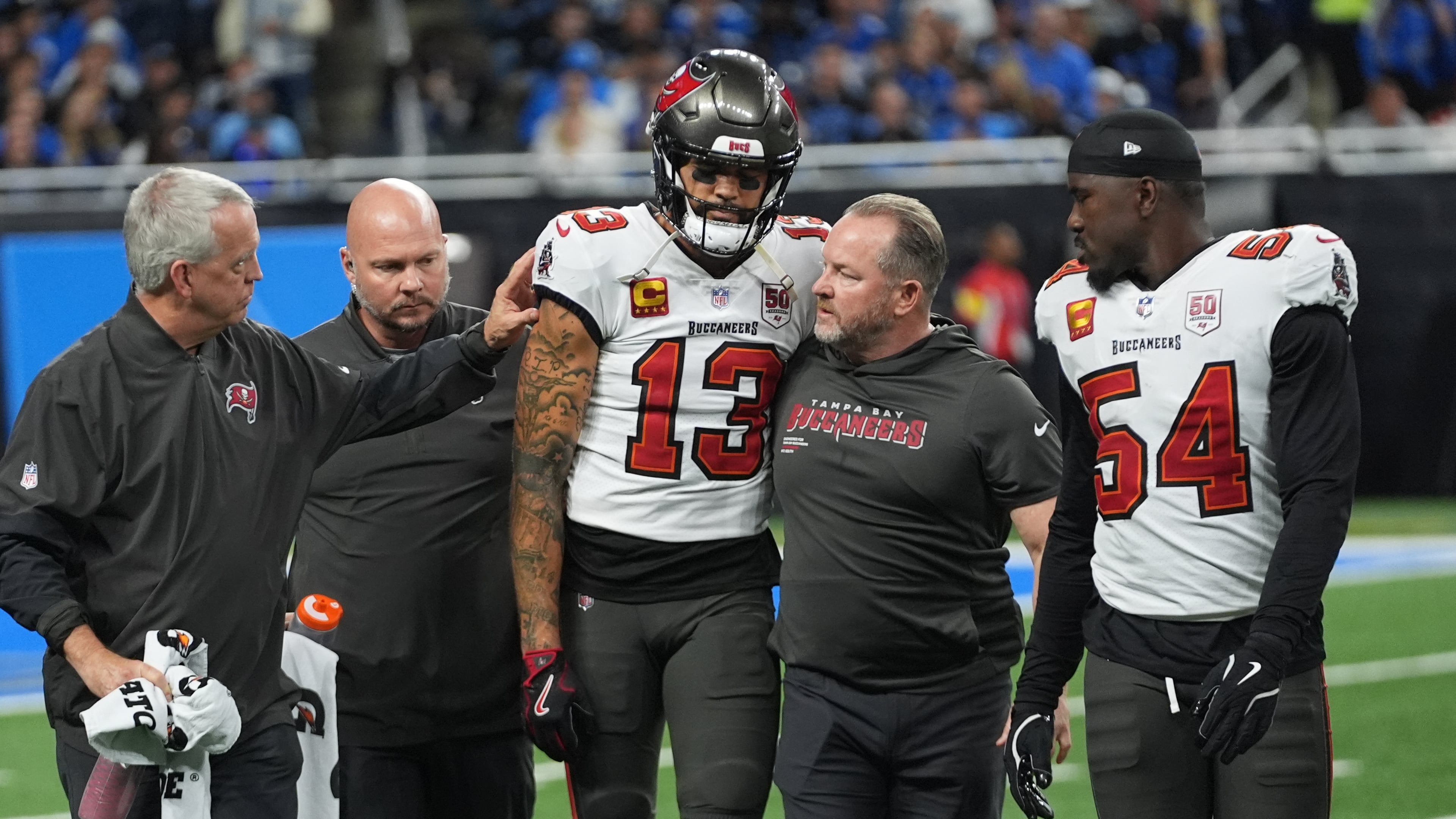 Tampa Bay Buccaneers wide receiver Mike Evans (13) is helped off the field after an injury during the first half of an NFL football game against the Detroit Lions, Monday, Oct. 20, 2025, in Detroit. AP Photo/Paul Sancya)
