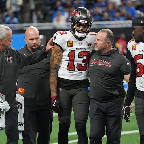 Tampa Bay Buccaneers wide receiver Mike Evans (13) is helped off the field after an injury during the first half of an NFL football game against the Detroit Lions, Monday, Oct. 20, 2025, in Detroit. AP Photo/Paul Sancya)