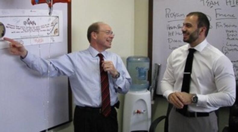 Dr. Matthew McKenna, left, talks with colleague Dr. Charbel El Bcheraoui in this undated photo. McKenna played important roles in studying, treating and helping contain diseases such as tuberculosis and HIV.