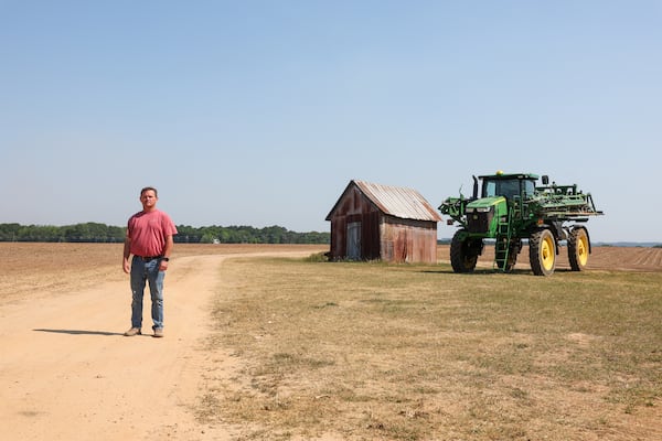Lee Nunn poses for a portrait at his field of newly planted cotton in Morgan County on April 23, 2026. Though this field is irrigated, Nunn would rather rely on rain than the costly irrigation system. (Arvin Temkar/AJC)