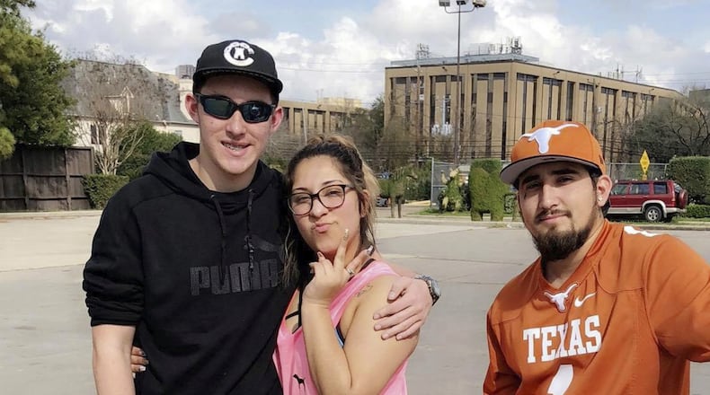 In this Feb. 18, 2018, photo provided by Ashley Fonseca, her cousin Christopher Riley Garcia, left, poses for a picture with Ashley and Robert Zamora in Houston. A gunman opened fire at Santa Fe High School on Friday, May 18, 2018, killing 10 people, including Garcia, in Santa Fe, Texas.