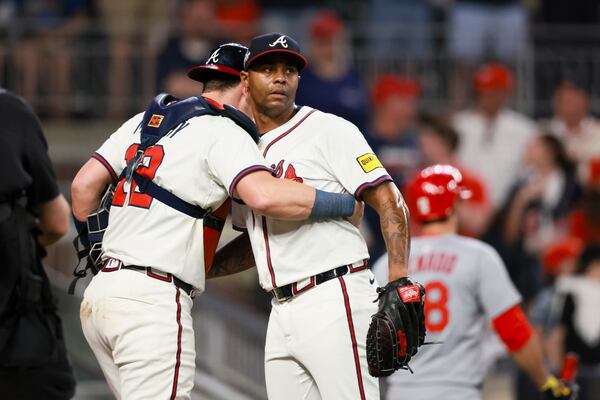 Braves closer Raisel Iglesias hugs catcher Sean Murphy after surviving Monday night's outing.