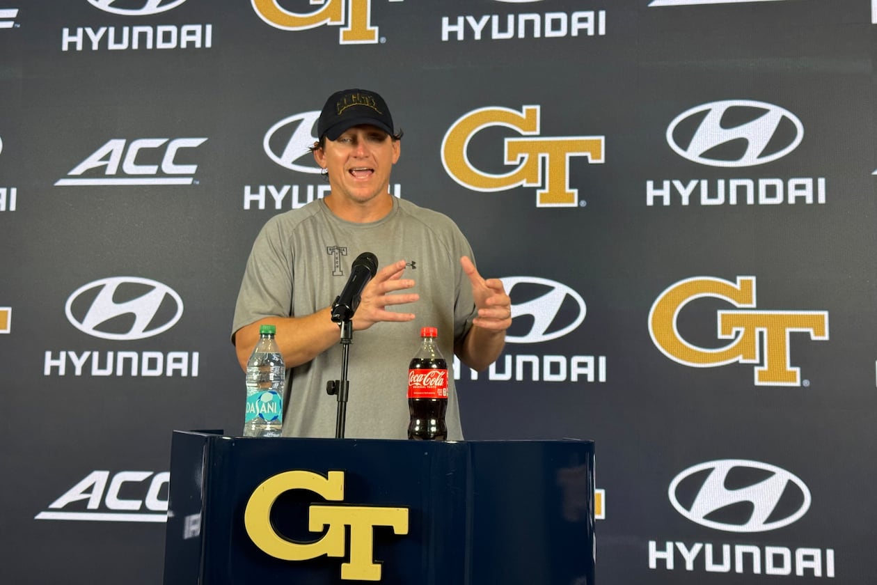 Georgia Tech offensive line coach Allen Mogridge speaks during a news conference after the Yellow Jackets’ seventh day of fall camp on Tuesday, Aug. 11, 2026, in Atlanta. Mogridge has worked to maintain a bond with offensive lineman Josh Petty. (Fisher Isbell/AJC)