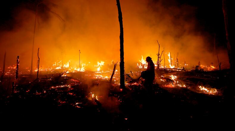 FILE - Firefighters work to put out a blaze in the Amazon forest during a drought and high temperatures in the rural municipality of Careiro Castanho, Amazonas state, Brazil, Oct. 21, 2023. (AP Photo/Edmar Barros, File)