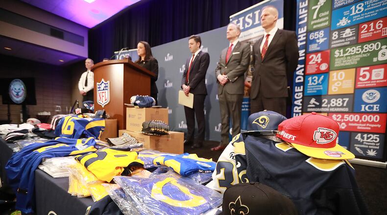 Fake NFL merchandise covers a table as the National Football League and law enforcement agencies announce the latest results of seizures of counterfeit game-related merchandise and tickets during a press conference at the Georgia World Congress Center on Thursday, Jan. 31, 2019, in Atlanta. Curtis Compton/ccompton@ajc.com