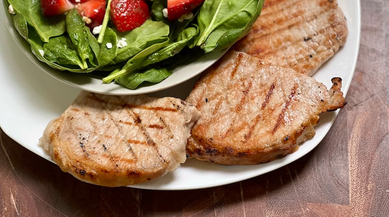 Brined, grilled pork chops are the ultimate easy, delicious summer meal.
Kellie Hynes for The Atlanta Journal-Constitution