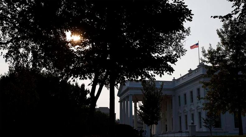 At midnight Sunday, shortly after President Trump's return from a weekend golf outing, the American flag was restored to full mast above the White House. (AP)
