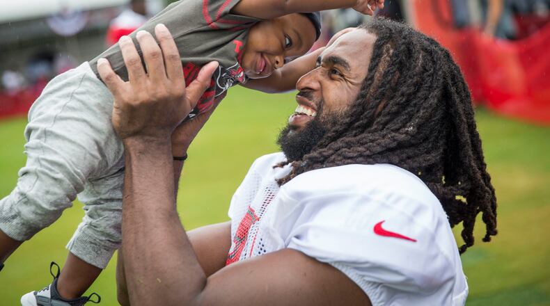 Tampa Bay Buccaneers defensive back J.J. Wilcox (27) holds son James Wilcox III, 7 months, after practice at training camp at One Buccaneer Place in Tampa, Fla., on Monday, July 31, 2017. (Loren Elliott /Tampa Bay Times via AP)