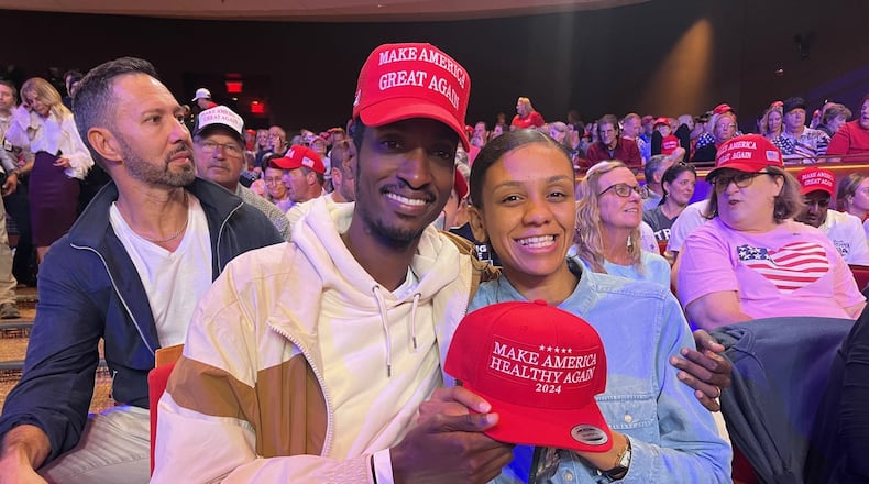 Arjenis Aten and his wife, Aliyah, attend the Donald Trump campaign rally at the Cobb Energy Performing Arts Centre on Oct. 15 - the first day of early voting. (Patricia Murphy/AJC)