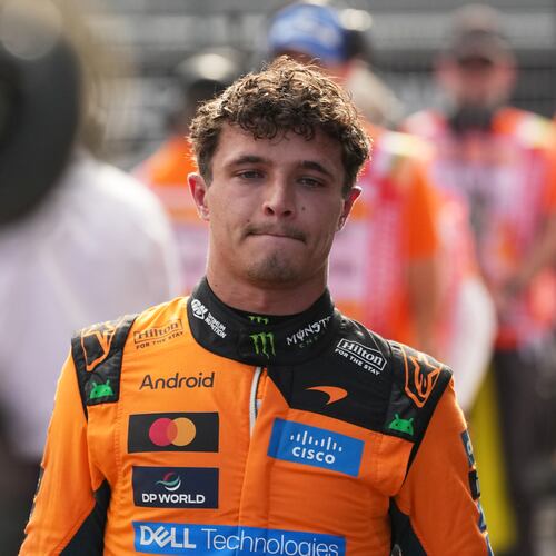 McLaren driver Lando Norris of Britain walks after winning the qualifying session ahead of Sunday's Formula One Hungarian Grand Prix auto race, at the Hungaroring racetrack in Mogyorod, near Budapest, Hungary, Saturday, July 25, 2026. (AP Photo/Darko Vojinovic)