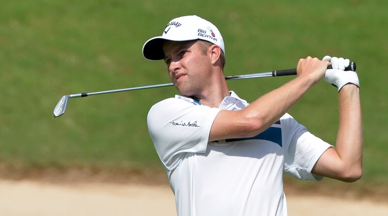 Chris Kirk, from Atlanta, hits his approach shot on the 8th hole during the opening round of the Tour Championship at East Lake Golf Club. The Tour Championship is the final tournament of golf's post season, the FedEx Cup. The winner of the cup takes home $10 million in prize money. BRANT SANDERLIN / BSANDERLIN@AJC.COM .