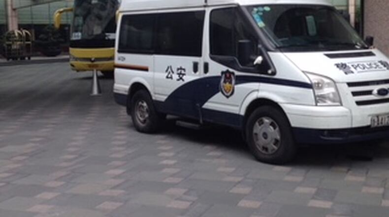 Police vehicle sits outside Georgia Tech team hotel as 3 players were investigated over several hours on Tuesday in Hangzhou, China. (AJC photo by Ken Sugiura)
