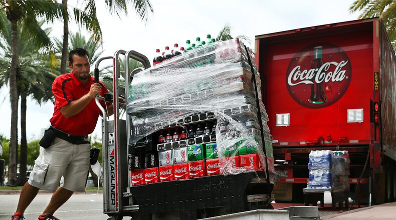 Scott McIntyre/Bloomberg An employee delivers cases of Coca-Cola brand sodas in Miami Beach, Florida, on Oct. 24, 2016. (MUST CREDIT: Scott McIntyre/Bloomberg)