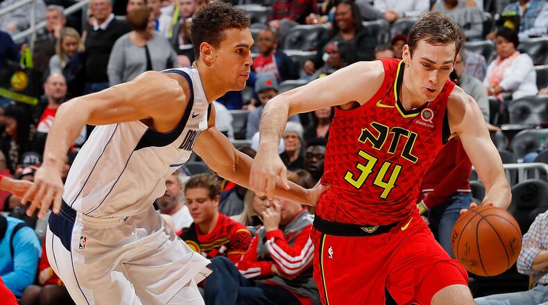 Tyler Cavanaugh (34) of the Atlanta Hawks drives against Dwight Powell (7) of the Dallas Mavericks at Philips Arena on December 23, 2017 in Atlanta, Georgia.   (Photo by Kevin C. Cox/Getty Images)