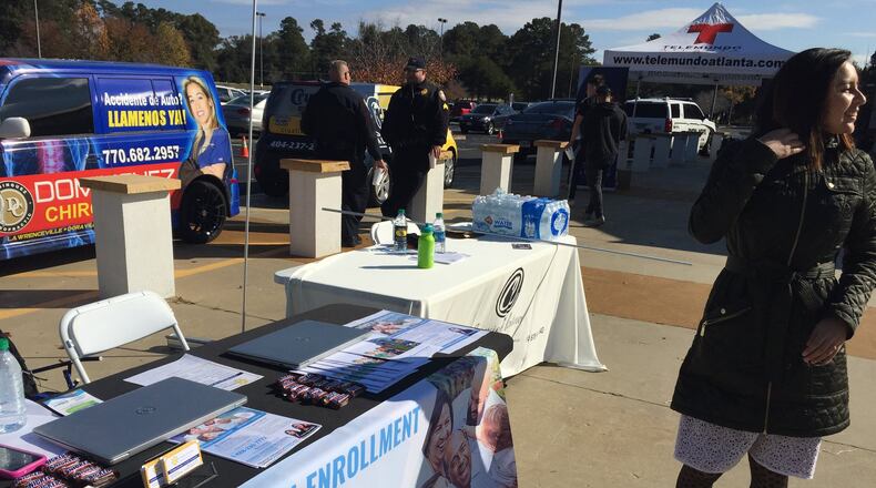 An Affordable Care Act navigator with Georgia Refugee Health and Mental Health, Viviana Cossio, stands beside the information table she has just set up to draw people to inquire to enroll in health care plans under the ACA, also known as Obamacare. The open enrollment period mostly drew to a close on Dec. 15. But in dozens of Georgia counties, people affected by Hurricane Michael have an extension to Feb. 20, 2019 to enroll. (PHOTO by Ariel Hart/AJC)