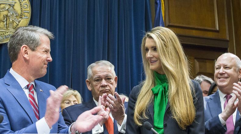 Lawmakers applaud as Kelly Loeffler, second from right, is introduced Dec. 4, 2019, by Gov. Brian Kemp, left, as his choice to succeed U.S. Sen. Johnny Isakson, who is stepping down for health reasons. ALYSSA POINTER / ALYSSA.POINTER@AJC.COM