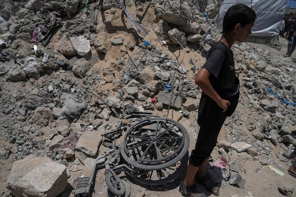 A kid stands next to the rubbles following an Israeli strike on tents sheltering displaced Palestinians in Gaza City on Tuesday, July 8, 2025. (AP Photo/Jehad Alshrafi)