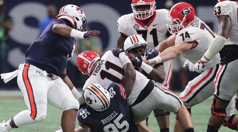 Georgia quarterback Jake Fromm (11) is sacked for a loss against Auburn during the first half of the SEC Championship game at Mercedes-Benz Stadium, December 2, 2017, in Atlanta.  Curtis Compton / ccompton@ajc.com