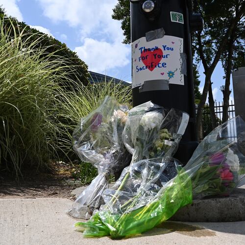Flowers are left outside the headquarters of the Centers for Disease Control and Prevention on Saturday, Aug. 9, 2025, after a deadly shooting Friday. A man opened fire on the CDC, killing a police officer who tried to stop him, authorities said. (Hyosub Shin/AJC)