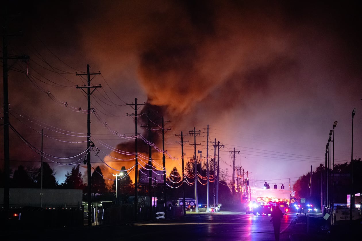 Plums of smoke rise from the area of a UPS cargo plane crash at Louisville Muhammad Ali International Airport, on Tuesday, Nov. 4, 2025, in Louisville, Ky. (AP Photo/Jon Cherry)