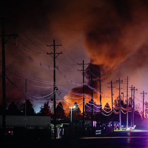 Plums of smoke rise from the area of a UPS cargo plane crash at Louisville Muhammad Ali International Airport on Tuesday, Nov. 4, 2025, in Louisville, Ky. (Jon Cherry/AP)