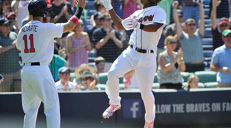 Mallex Smith leaps in the air after sliding in safely to score the game-tying run in the eighth. (AP Photo/John Amis)