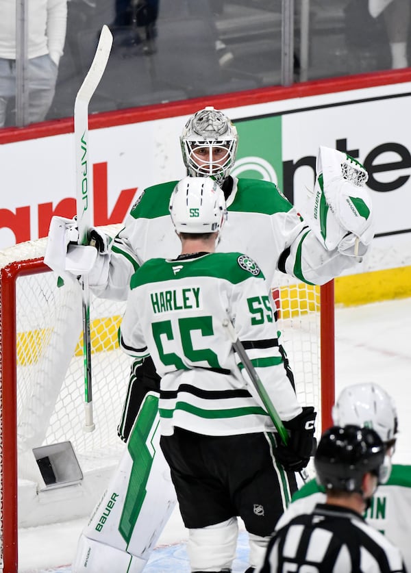 Dallas Stars goaltender Jake Oettinger (29) celebrates the win over the Winnipeg Jets with Thomas Harley (55) in NHL playoff hockey action in Winnipeg, Canada, Wednesday, May 7, 2025. (Fred Greenslade/The Canadian Press via AP)