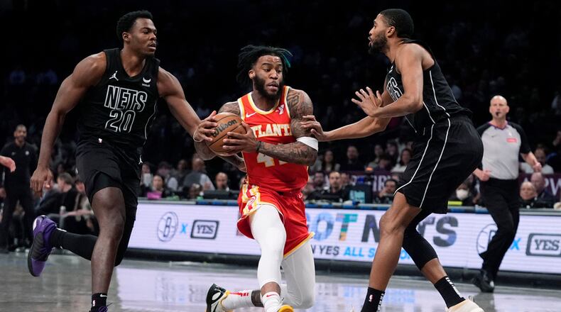 Forward Saddiq Bey has been a force for the Hawks in the paint this season. Here he drives past Day'Ron Sharpe (20) and Mikal Bridges of the Nets during the first half of the Hawks-Nets game Feb. 29, 2024, in New York. (AP Photo/Frank Franklin II)