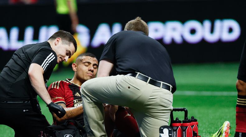 Atlanta United forward Giorgos Giakoumakis (7) gets assistance from the team’s doctors after a play during the first half against the Chicago Fire at Mercedes-Benz Stadium on Sunday, March 31, 2024.
 Miguel Martinez / miguel.martinezjimenez@ajc.com
