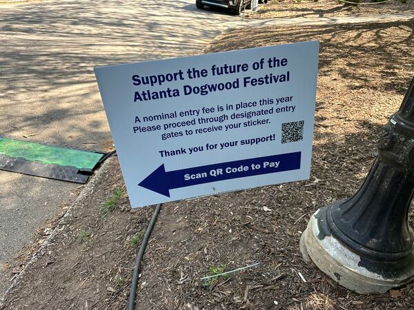The Dogwood Festival had signage about its gate entry fee at four entrances at Piedmont Park over the weekend, but since the park wasn't fenced off, attendees could easily skirt the entrances and enter the festival for free. (Rodney Ho/AJC)