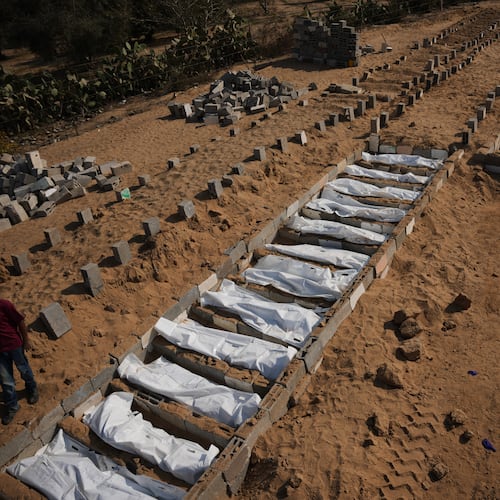 Bodies of unidentified Palestinians returned from Israel as part of the ceasefire deal are buried in a mass grave in Deir al-Balah, Gaza Strip, Wednesday, Nov. 5, 2025. (AP Photo/Abdel Kareem Hana)