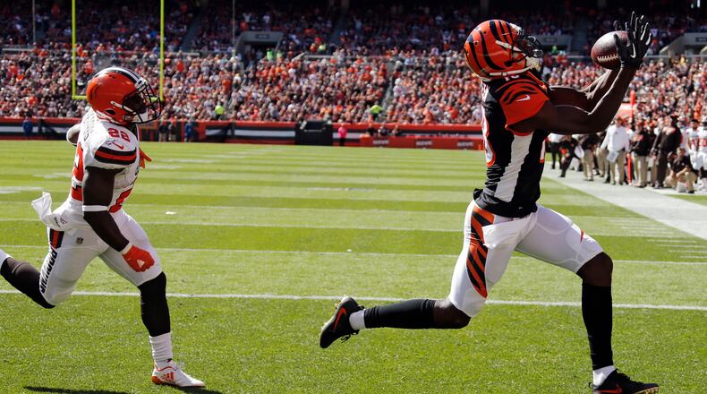 Cincinnati Bengals wide receiver A.J. Green, right, reaches for a ball after a 7-yard pass for a touchdown in the first half of an NFL football game against the Cleveland Browns, Sunday, Oct. 1, 2017, in Cleveland. (AP Photo/Ron Schwane)