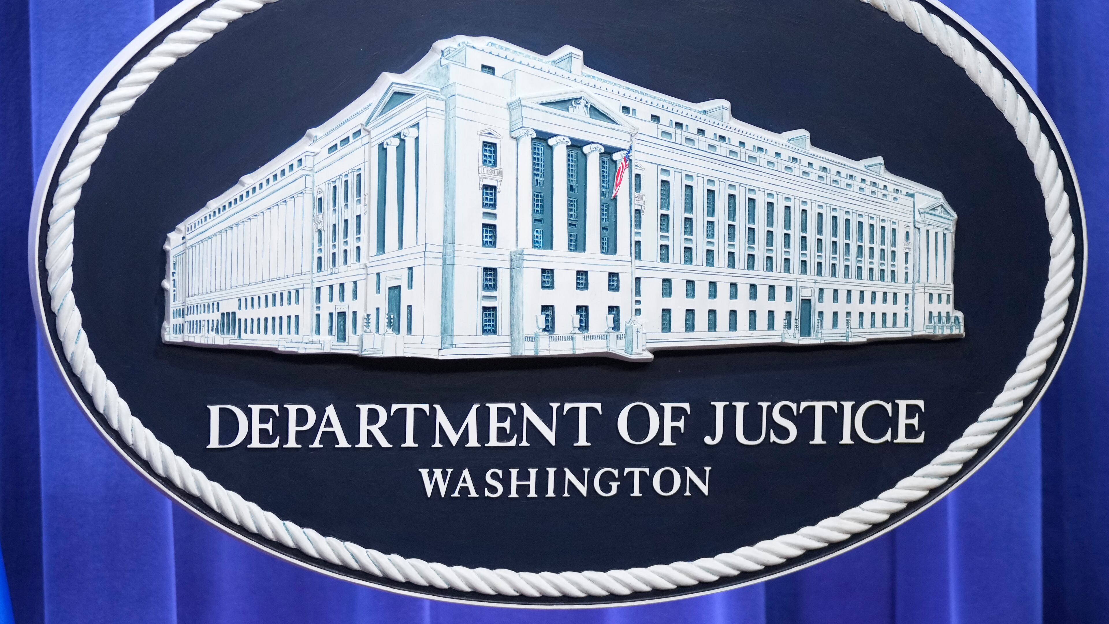The Department of Justice seal is seen at the Justice Department, Wednesday, Nov. 19, 2025, in Washington. (AP Photo/Mark Schiefelbein)