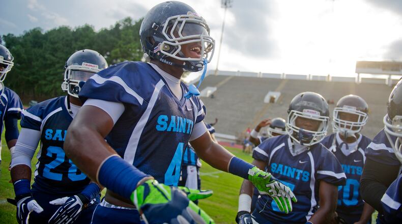 Cedar Grove's Bryson Allen-Williams (center) gets his teammates pumped before their game against Tucker at Panthersville Stadium in Decatur on Friday, August 23, 2013. JONATHAN PHILLIPS / SPECIAL