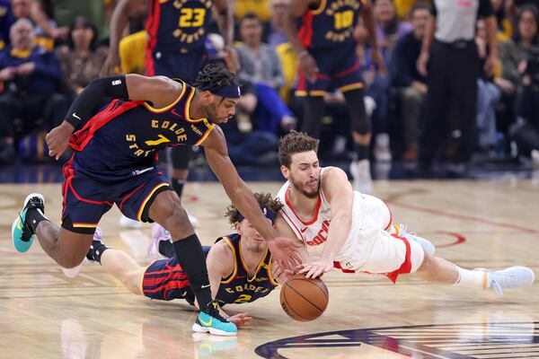 Golden State Warriors' Brandin Podziemski and Buddy Hield team up to control loose ball against Houston Rockets' Alperen Sengun in the first half of an NBA Playoffs' First Round Game 4 at Chase Center in San Francisco on Monday, April 28, 2025.(Scott Strazzante/San Francisco Chronicle via AP)