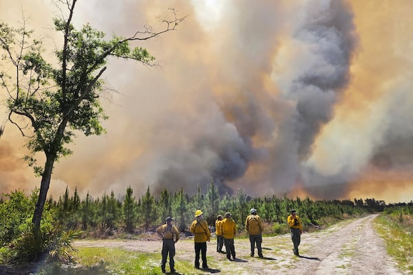 This photo provided by the Georgia Department of Natural Resources shows firefighters responding to the Pineland Road Fire in South Georgia on Wednesday, April 22, 2026. (Georgia Department of Natural Resources via AP)