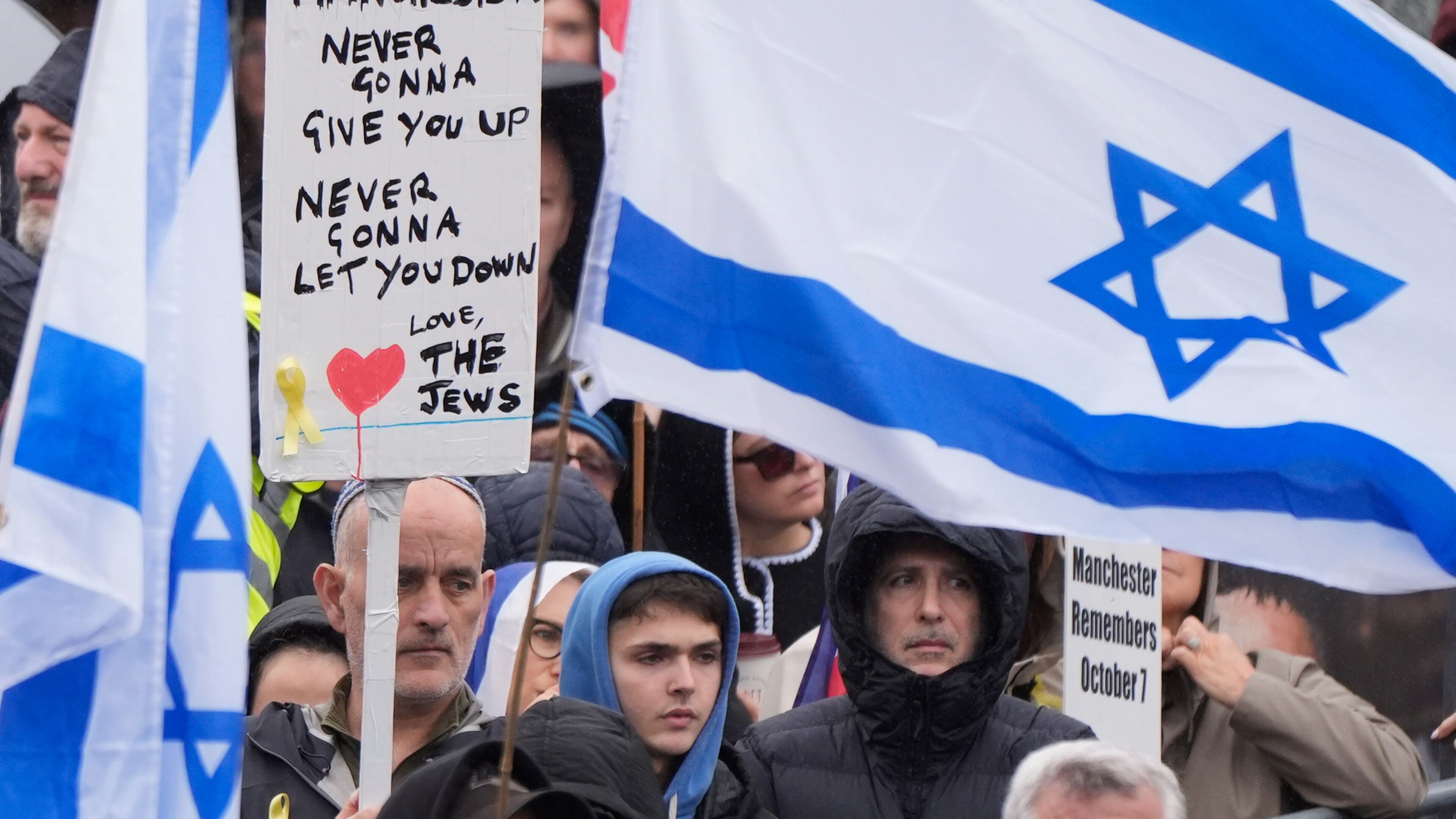 People attend a protest outside Manchester Cathedral following an attack at Heaton Park Hebrew Congregation synagogue in Crumpsall, where two people died, in Manchester, England, Sunday Oct. 5, 2025. (Danny Lawson/PA via AP)