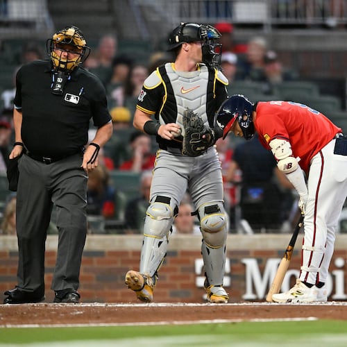 Braves shortstop Ha-Seong Kim (right) — pictured after striking out in a September game — will miss four to five months after sustaining a hand injury while in Korea. Kim had surgery Sunday to repair a torn tendon in his right middle finger. (Hyosub Shin/AJC 2025)