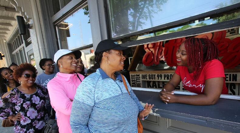 Customers wait in line at Slutty Vegan, owned by Pinky Cole. The vegan restaurant sells 1,600 burgers daily. TYSON A. HORNE / TYSON.HORNE@AJC.COM