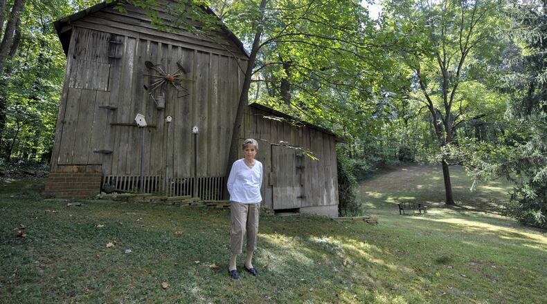 Wylene Tritt, 84, poses for a portrait behind her family’s barn in Marietta, Georgia, on Monday, October 3, 2016. The barn was built by Tritt’s father-in-law, Will Tritt in the 1940’s. (DAVID BARNES / DAVID.BARNES@AJC.COM)