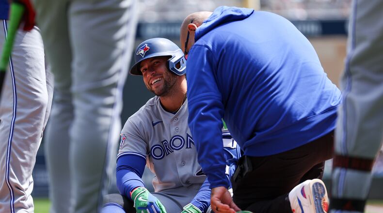 Toronto Blue Jays designated hitter George Springer is tended to after getting hit by a pitch during the third inning of a baseball game against the Minnesota Twins, Saturday, May 2, 2026, in Minneapolis. (AP Photo/Matt Krohn)