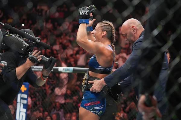 Kayla Harrison celebrates after winning her women's bantamweight bout against Julianna Peña at the UFC 316 mixed martial arts event Sunday, June 8, 2025 in Newark, N.J. (AP Photo/Frank Franklin II)