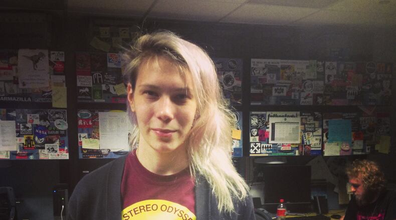 Ana Zimitravich, outgoing GM for WRAS, holds the hashtag students are trying to use to get the word out. CREDIT: Rodney Ho/rho@ajc.com