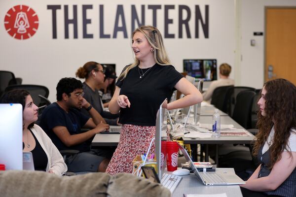 Emma Wozniak, editor in chief of the Ohio State University's The Lantern newspaper, talks with Nora Igelnik, left, Lantern campus editor and managing editor of content, Lucy Lawler at the university's news offices in Columbus, Ohio, Thursday, April 24, 2025. (AP Photo/Joe Maiorana)